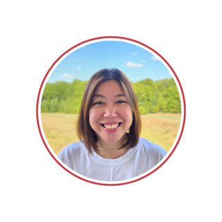 Hara Jun, an Asian woman with shoulder length hair wearing a white shirt in front of an outdoor background.